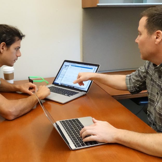 two people looking at computer screen